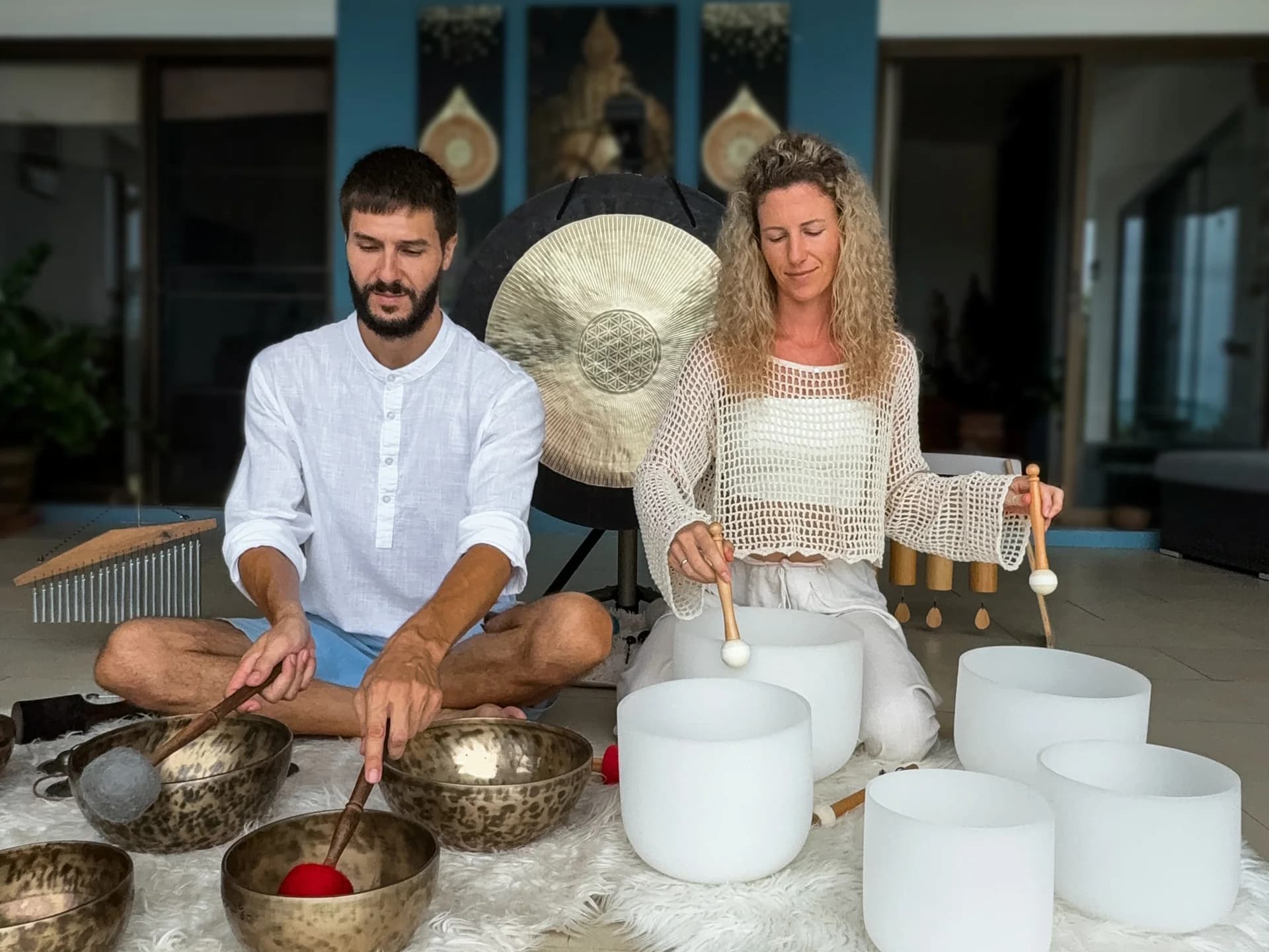 Max and Olha guiding a sound healing and Yoga Nidra workshop in their Koh Samui studio with singing bowls and gongs